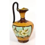 A Doulton Lambeth faience jug in the form of a Grecian ewer, decorated with flora,