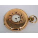 A 9ct gold crown wind half hunter pocket watch the enamel dial set with Arabic numerals and