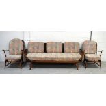 An Ercol stick back sofa, width 204cm and a pair of matching armchairs (3).