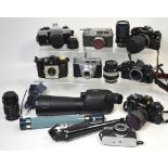 A quantity of cameras and lenses to include a Canon A-1 camera body with 28-70mm Tamron lens,