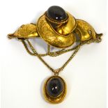 A Victorian yellow metal and cabochon garnet set brooch,