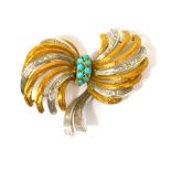 An 18ct white and yellow gold brooch of abstract scrolling bow design with eight central turquoise