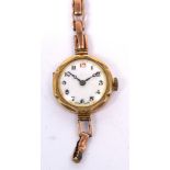 A 9ct yellow gold ladies' wristwatch, the enamel dial set with Arabic numerals,