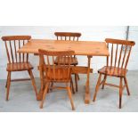 A pine refectory-style dining table, width 117cm and a set of four matching stick back chairs (5).