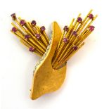 A yellow metal brooch of abstract design set with diamonds and floral style sprays set with rubies,