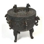 A 20th century Oriental metal covered incense pot raised on three outstretched supports,