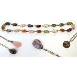 A quantity of ladies' dress necklaces all set with semi precious stones, including amethyst,