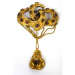 A Victorian yellow metal and garnet set brooch,