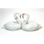 A boxed Lladró figure group of two kissing swans, length 27cm.