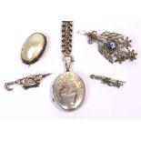 A Victorian hallmarked silver locket on white metal chain, two Victorian hallmarked silver brooches,