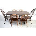 An Ercol refectory style dining table raised on twin end slab supports with conjoining stretcher,