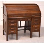 A 20th century oak eight drawer roll top bureau,