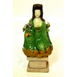 An early Chinese famille vert bisque figure of a seated Guanyin on a lotus throne, approx height 15.