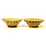 A pair of Cizhou pottery bowls of ogee form, partially covered in cream crackling glaze,