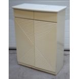 A 20th century cream painted larder cupboard with two short drawers above lower twin doors with