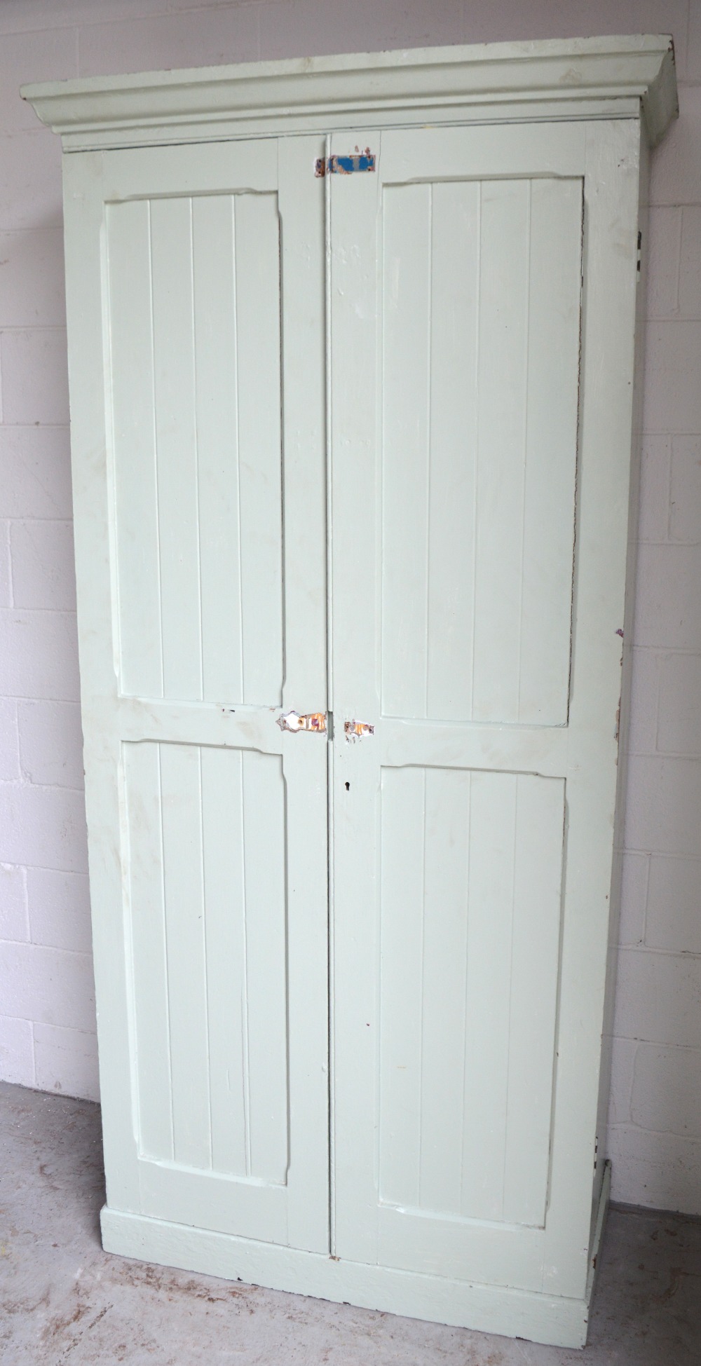 A Victorian painted pine two-door linen press with fitted interior of adjustable shelves,