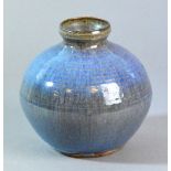 CONSTANCE DUNN; a stoneware vase covered in a thick streaky blue glaze over a ribbed body,