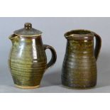 Leach Pottery; a stoneware coffee pot and matching water jug covered in mottled dark green,