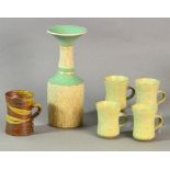 Winchcombe Pottery: four small stoneware mugs, a Jane Hamlyn mug and a vase marked JR,