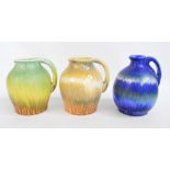 Three large Ruskin drizzle glaze decorated jugs with simple loop handles,