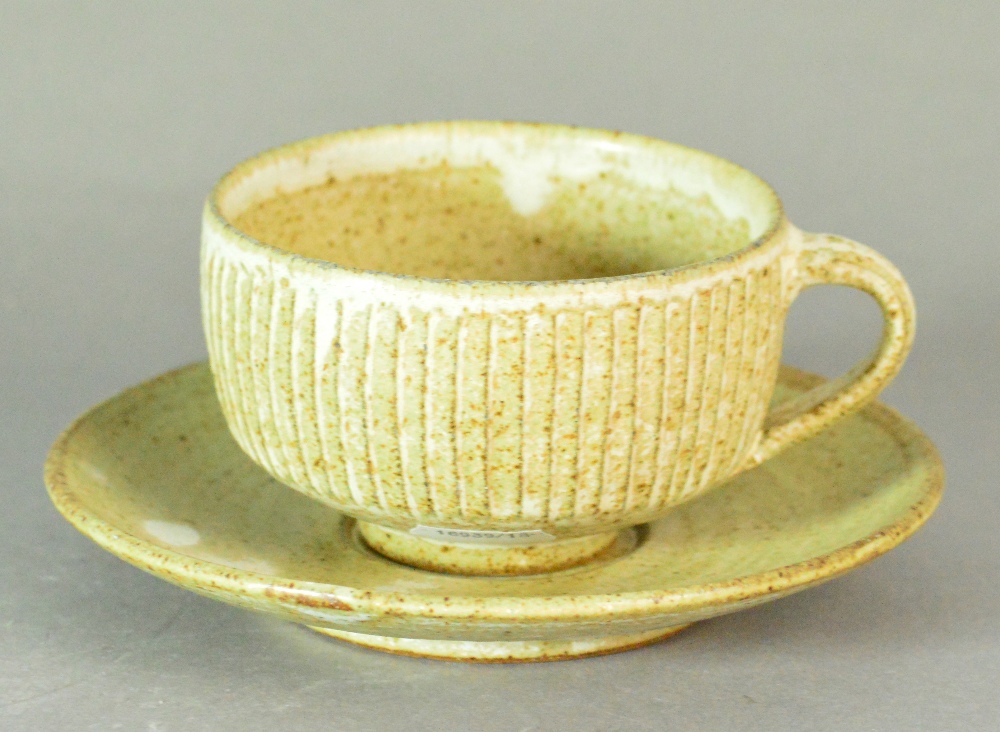 Lowerdown Pottery; a fluted stoneware cup and saucer, impressed L+ mark, cup height 6.5cm.