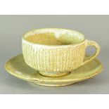 Lowerdown Pottery; a fluted stoneware cup and saucer, impressed L+ mark, cup height 6.5cm.