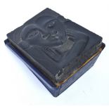 In the manner of Eric Gill, an unusual carved slate sculpture, entwined faces forming a heart,