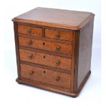 A miniature walnut two-over-three chest of drawers, width 30cm.