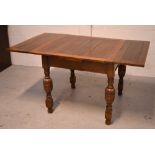 A 20th century oak extending dining table on bulbous supports, width when extended 152cm.