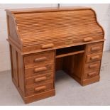 A 20th century light oak roll-top desk,