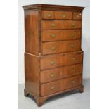 A George III walnut chest-on-chest with base of three long drawers below a chest of three short