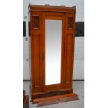 An Edwardian walnut single-door mirrored wardrobe raised on a plinth base (af), 200 x 98cm.