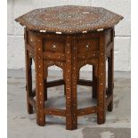 An Indian hardwood octagonal table inlaid with ivory, the top raised on a folding sectional base,