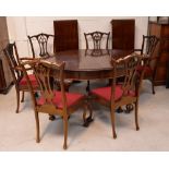 A large 20th century oval mahogany extending dining table raised on knee carved ball and claw feet,