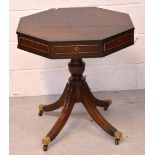 A reproduction mahogany octagonal side table on quatrefoil support and castors, diameter 60cm.