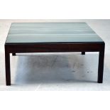 A modern mahogany coffee table with green slate base, 76 x 76cm.