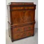 A mid Victorian secretaire chest in flame mahogany,