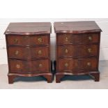 A pair of reproduction mahogany bow front bedside cabinets, three drawers on bracket supports,