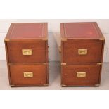 A pair of mahogany Oriental inspired side cabinets with recessed brass handles and brass decoration,