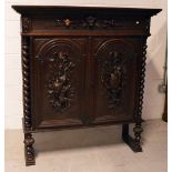 A late Victorian carved oak side cabinet,