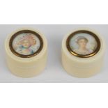 A late 19th century pair of ivory trinket boxes of cylindrical form with screw lids topped with