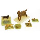 A green onyx ashtray surmounted by a spelter model of a dog, a similar smaller example,