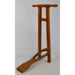 An early 20th century pale mahogany boot jack with twin handles.