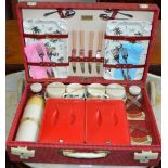 A 1950s Brexton picnic case with knives and forks and crockery in South Pacific pattern for four