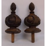A pair of late 19th century carved finials of squat globular form with turned bases,