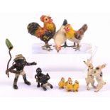 A group of five miniature cold painted figures including two hares dancing, a group of four chicks,