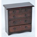 A miniature Victorian stained wooden chest of two short drawers above three long drawers,