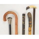 Five various walking sticks including a Victorian hallmarked silver handled and ebonised example,