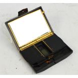 A 1930s Art Deco style tortoiseshell compact, with compartmentalised mirrored interior,