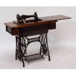 A freestanding Singer sewing machine.